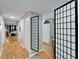 Hallway with wood floors leading to the kitchen, dining room, and living room areas at 4917 Puritan Cir, Tampa, FL 33617