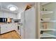 Bright kitchen featuring white appliances and cabinetry with built in corner shelves at 4917 Puritan Cir, Tampa, FL 33617