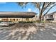 Assigned covered parking area in front of this well-maintained condominium complex with mature landscaping at 4917 Puritan Cir, Tampa, FL 33617