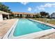 Community pool with sundeck and lounge chairs at 4917 Puritan Cir, Tampa, FL 33617