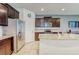 Well-lit kitchen features stainless steel appliances, a tile backsplash, and a large granite countertop island at 4925 White Sanderling Ct, Tampa, FL 33619