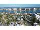 Aerial view of a residential neighborhood near a body of water and high-rise buildings in the distance at 50 Acacia St, Clearwater Beach, FL 33767