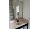 Bathroom vanity with pink countertop, black hardware, and a large mirror at 50 Acacia St, Clearwater Beach, FL 33767