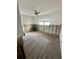 Unfinished bedroom with exposed block walls, ceiling fan, and hardwood floors at 50 Acacia St, Clearwater Beach, FL 33767