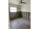 Unfinished bedroom with exposed block walls, ceiling fan, and hardwood floors at 50 Acacia St, Clearwater Beach, FL 33767