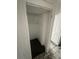 A small, empty closet with one shelf, inside a house in need of repair at 50 Acacia St, Clearwater Beach, FL 33767