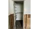 Damaged closet interior with shelves and hanging rod; in need of repair at 50 Acacia St, Clearwater Beach, FL 33767