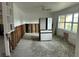 A distressed living room shows floors damaged by water and exposed walls at 50 Acacia St, Clearwater Beach, FL 33767