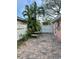 Small patio with pavers, a stone table, and a privacy fence at 50 Acacia St, Clearwater Beach, FL 33767