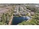 Aerial view of townhome community, showing the surrounding lake, pool, and neighborhood layout at 5507 Cumberland Star Ct, Lutz, FL 33558