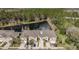 Aerial view of townhomes backing to a pond and lush landscaping, showing privacy and curb appeal at 5507 Cumberland Star Ct, Lutz, FL 33558