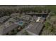 Aerial view of a community with a swimming pool, cabana, and a tranquil lake surrounded by lush trees at 5507 Cumberland Star Ct, Lutz, FL 33558