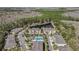 Aerial view of community with a swimming pool and lake surrounded by trees showcases the neighborhood's layout at 5507 Cumberland Star Ct, Lutz, FL 33558