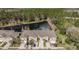 Aerial view of townhomes backing to a pond and lush landscaping, showing privacy and curb appeal at 5507 Cumberland Star Ct, Lutz, FL 33558