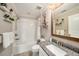 Bathroom with tub-shower combo, and a granite vanity with decorative shelving at 5507 Cumberland Star Ct, Lutz, FL 33558