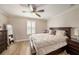 Bedroom features wood floors, a shuttered window, and a decorative full length mirror at 5507 Cumberland Star Ct, Lutz, FL 33558