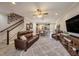 Open concept living room with wood floors, a ceiling fan and staircase to the second floor at 5507 Cumberland Star Ct, Lutz, FL 33558