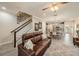 Open concept living room with wood floors, a ceiling fan and staircase to the second floor at 5507 Cumberland Star Ct, Lutz, FL 33558