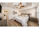 Tranquil main bedroom features a tray ceiling, wood floors, and shuttered windows at 5507 Cumberland Star Ct, Lutz, FL 33558