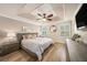 Tranquil main bedroom features a tray ceiling, wood floors, and shuttered windows at 5507 Cumberland Star Ct, Lutz, FL 33558