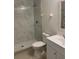 Updated bathroom features a glass-enclosed shower and modern vanity at 5729 13Th St, Zephyrhills, FL 33542