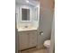 Charming bathroom featuring a white vanity, a framed mirror, and a toilet at 5729 13Th St, Zephyrhills, FL 33542