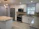 Modern kitchen features stainless steel appliances, granite countertops, shaker cabinets, and a tiled backsplash at 5729 13Th St, Zephyrhills, FL 33542