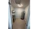 Utility room with tile floors, utility sink, water heater, and shelving at 5729 13Th St, Zephyrhills, FL 33542