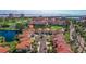 A high angle view showcases residences with red tile roofs, near a golf course and ponds at 6105 Mirada Cir, St Petersburg, FL 33715