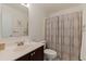 Bright bathroom featuring a vanity with dark wood cabinets and a shower with patterned curtain at 6105 Mirada Cir, St Petersburg, FL 33715