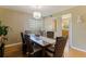 Cozy dining room area with a modern chandelier, hardwood floors, and view to the kitchen at 6105 Mirada Cir, St Petersburg, FL 33715