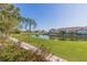 Exterior view showcases a lush green golf course and serene pond with residences in the background at 6105 Mirada Cir, St Petersburg, FL 33715