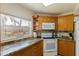 Well-lit kitchen boasts granite countertops and stainless-steel appliances at 6105 Mirada Cir, St Petersburg, FL 33715