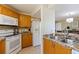 Well-lit kitchen with wooden cabinets, granite countertops, and modern appliances at 6105 Mirada Cir, St Petersburg, FL 33715