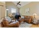 Cozy living room featuring a high ceiling, comfortable leather seating, and a ceiling fan at 6105 Mirada Cir, St Petersburg, FL 33715