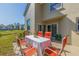 Back patio with table and orange chairs offers serene outdoor dining at 6105 Mirada Cir, St Petersburg, FL 33715