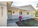 Charming front porch of a light-colored home with stylish door and well-manicured landscaping at 6121 38Th W Ave, Bradenton, FL 34209