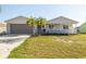 Charming single-story home with a well-manicured lawn, beautiful landscape, and a cozy front porch at 6121 38Th W Ave, Bradenton, FL 34209