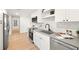 Well-lit kitchen featuring stainless steel appliances, white cabinets, and open shelving at 6121 38Th W Ave, Bradenton, FL 34209