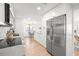 Bright kitchen with stainless steel refrigerator and modern appliances adjacent to the dining area at 6121 38Th W Ave, Bradenton, FL 34209