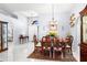 Elegant dining room featuring tile floors, a chandelier, and a seamless transition to the foyer and kitchen areas at 6426 Gondola Dr, Riverview, FL 33578