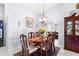 Bright dining room with a traditional table set, chandelier lighting, and views into the kitchen and living spaces at 6426 Gondola Dr, Riverview, FL 33578