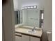 Bright bathroom vanity with a large mirror and overhead lighting at 6439 Cypressdale Dr # 202, Riverview, FL 33578