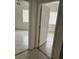 Hallway view featuring two doorways leading into rooms with tiled floors at 6439 Cypressdale Dr # 202, Riverview, FL 33578