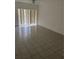 Bright living room with tile floors and large vertical blinds in front of the windows at 6439 Cypressdale Dr # 202, Riverview, FL 33578