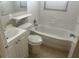 Clean bathroom featuring a tiled bathtub, a toilet and vanity at 6601 65Th N Way, Pinellas Park, FL 33781