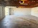 Unfinished garage featuring a concrete floor and open garage door at 6601 65Th N Way, Pinellas Park, FL 33781