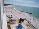 Aerial view of pristine white sand beach, palm trees, and ocean from condo at 7000 Beach Plz # 805, St Pete Beach, FL 33706