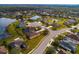 An aerial view of a suburban neighborhood with homes surrounding a pond and cul-de-sac at 7304 63Rd E Ct, Palmetto, FL 34221