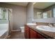 Full bathroom boasting double sinks, granite countertop, tub, and a glass shower at 7304 63Rd E Ct, Palmetto, FL 34221